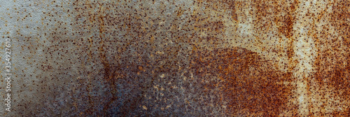 Abstract rusty metal background of painted metal texture with traces of corrosion. Panorama. Close up.