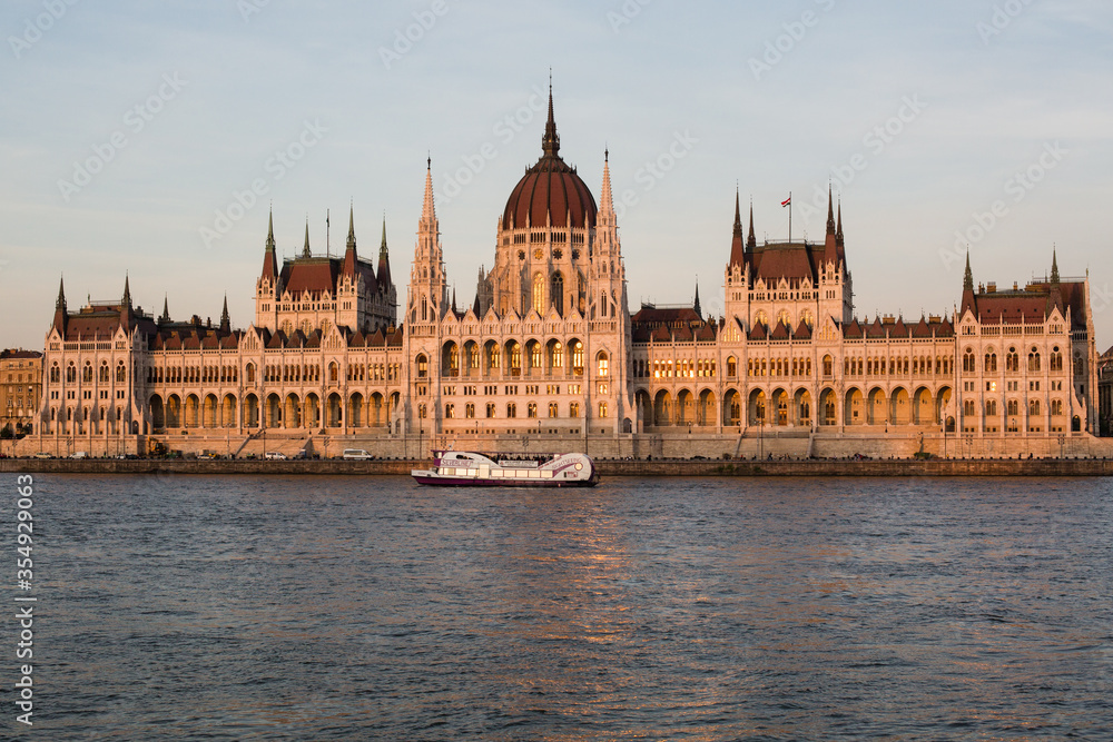 Budapest parliament building at sunset golden time with blue and Danube river