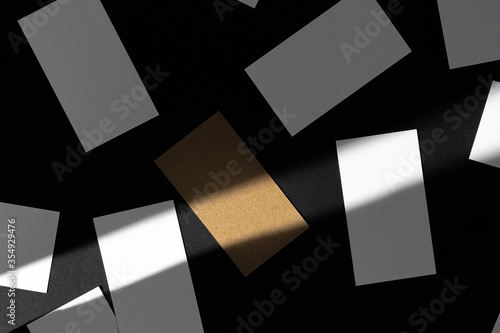 Blank businesscards on black background. Creative photo with shadows photo