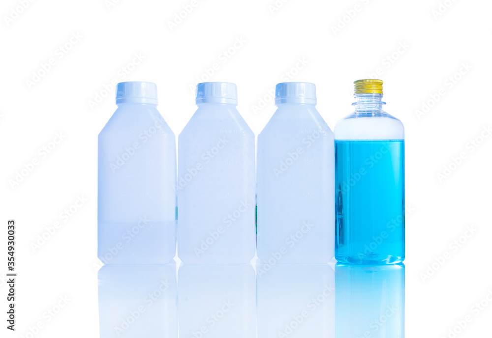 three white gallons and one blue bottle alcohol 70% on white background. three white gallons and one blue bottle alcohol 70% on white background.