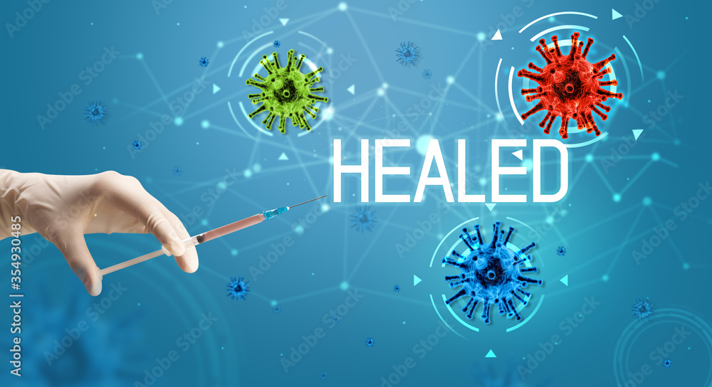 Syringe, medical injection in hand with HEALED inscription, coronavirus vaccine concept Syringe, medical injection in hand with HEALED inscription, coronavirus vaccine concept