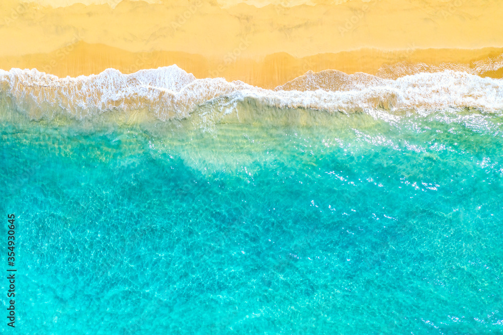 Summer vacation background. Drone aerial view of turquoise ocean waves and the sandy coastline. Exotic tropical beach in Dominican Republic