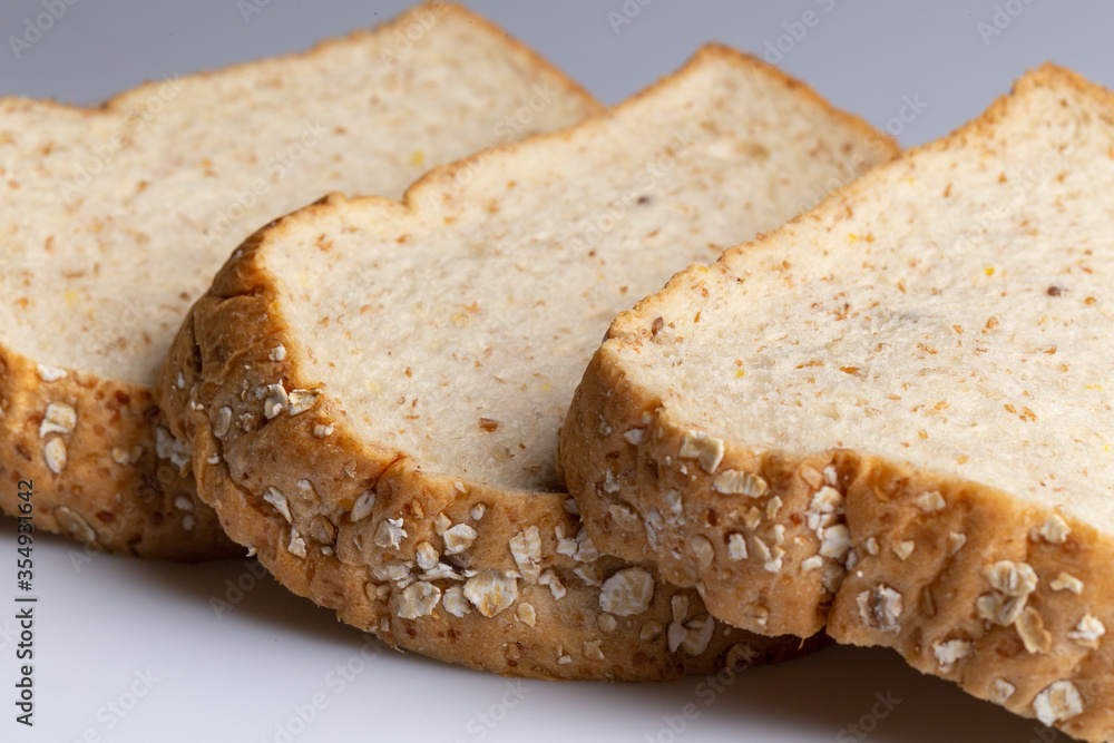 Whole wheat bread isolated on white background. Slice bread, made from 12 kinds of grains, clearly portray the texture and look delicious.