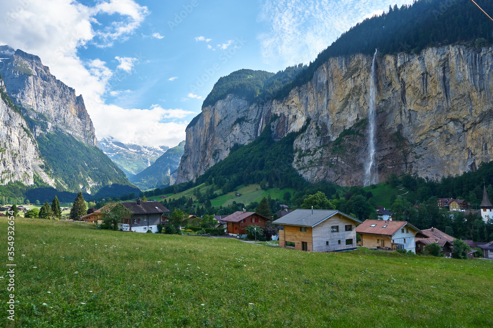 Landscape panorama of Lauterbrunnen Valley with its famous waterfall and green nature, Switzerland