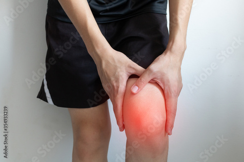 Knee pain after exercise concept. Man holds on his knee after knee injury. Inflammation or arthritis concept for graphic design and poster.
