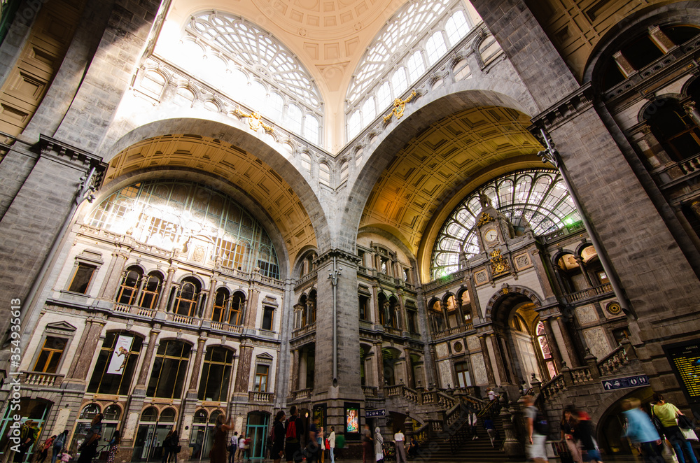 Antwerp, Flanders, Belgium. August 2019. The historic entrance hall of the central railway station is so large and finely decorated that it earns the title of cathedral of the stations. People.