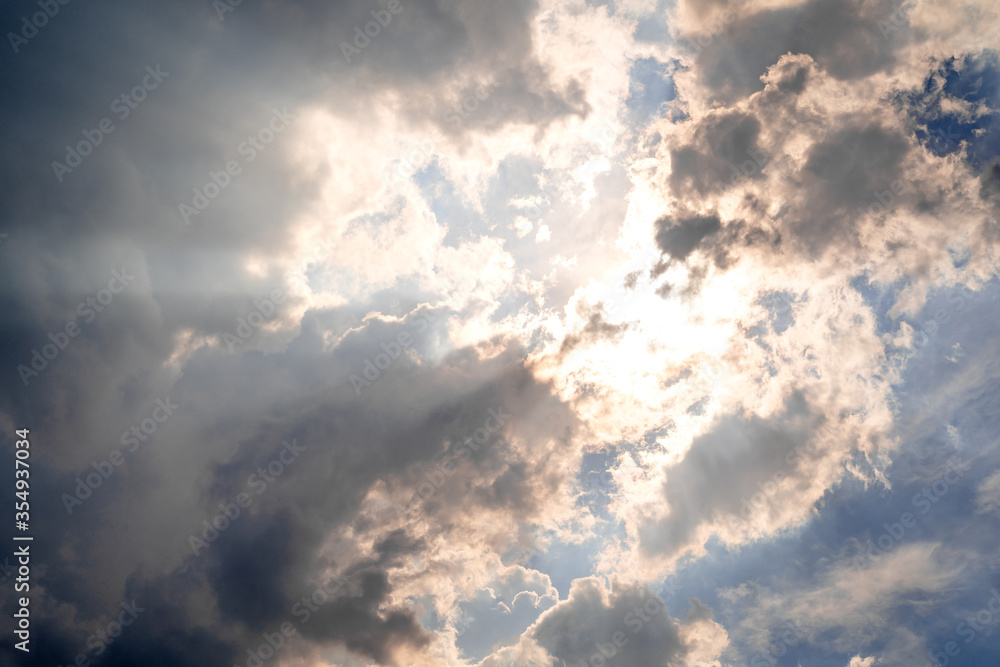 The sky with sunlight shining through the rain clouds. The sky with sunlight shining through the rain clouds.