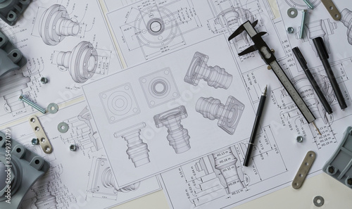 Engineer technician designing drawings mechanical parts engineering Engine.manufacturing factory Industry Industrial work project blueprints measuring bearings caliper tools