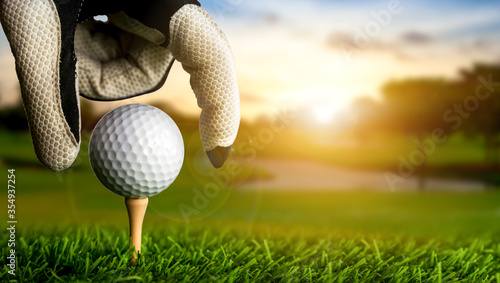 Obraz na plátně Hand of golfer putting golf ball on the tee.