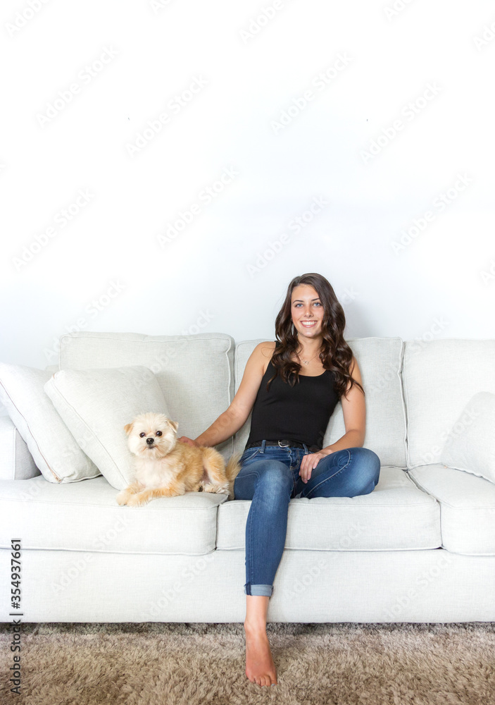 Beautiful young model with brown hair posing on white couch. Beautiful young model with brown hair posing on white couch.