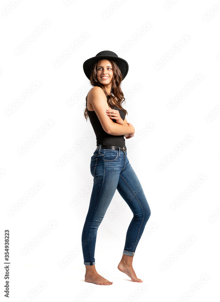 Beautiful Young Model posing in dress and hat on white background
