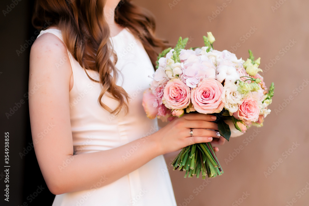 Wedding bouquet of roses at the bride's hands Wedding bouquet of roses at the bride's hands