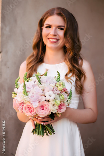 Wedding bouquet of roses at the bride's hands