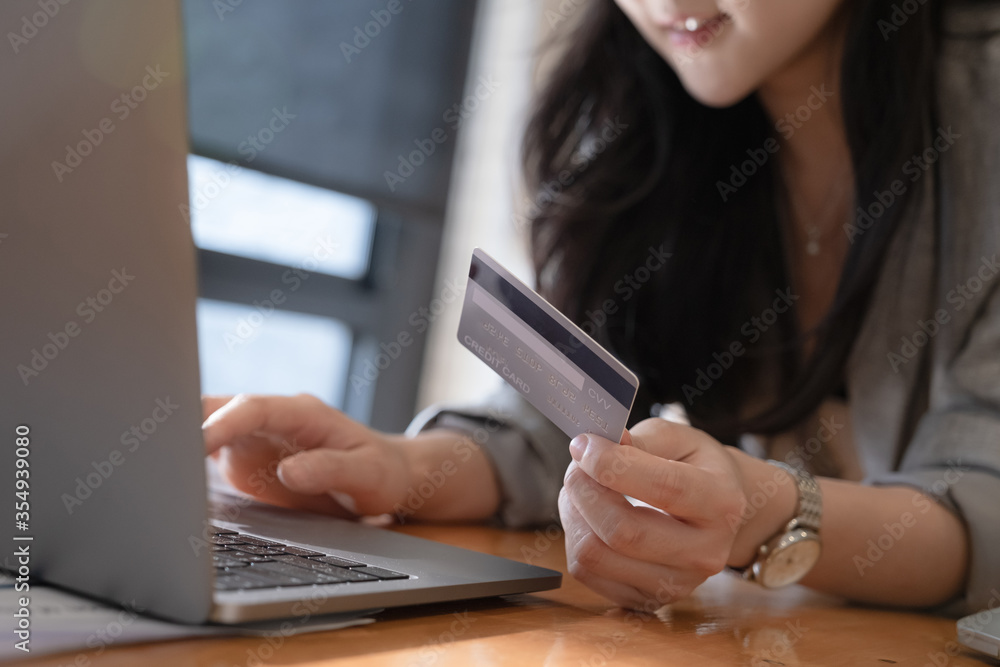 Online Shopping. Asian woman typing credit card information by laptop for shopping online. Online Shopping. Asian woman typing credit card information by laptop for shopping online.
