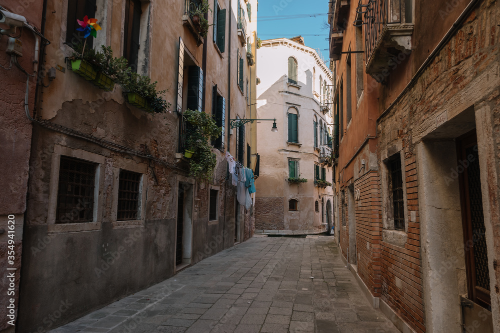 Deserted street of Venice and only linen is dried on a rope, Italy.