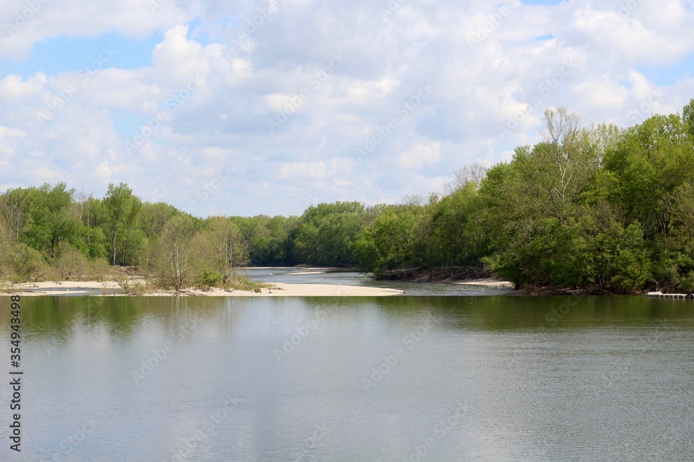 A view of the flowing river from the riverbank.