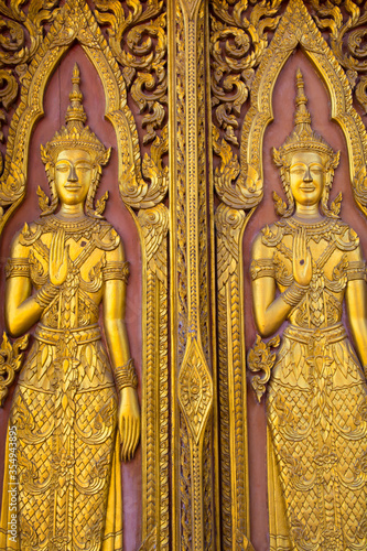 Thai golden angel sculptures stucco on the temple walls © serra715