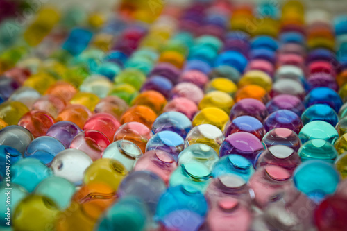 Water colourful gel balls. Polymer gel. Silica gel. Balls of colourful hydrogel. Crystal liquid ball with reflection. Texture background. Close up macro.