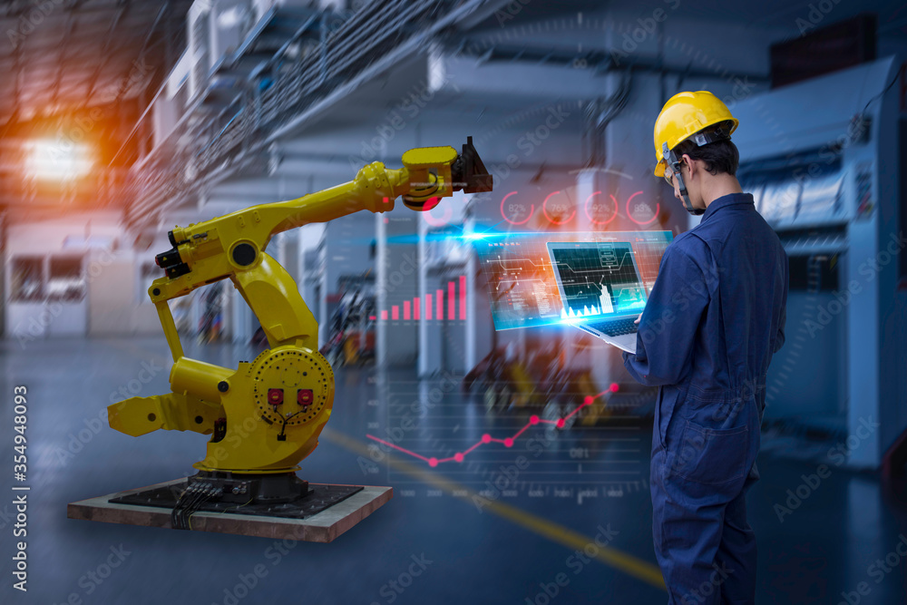 Industry 4.0 Robot concept .Engineers use laptop computers for machine ...