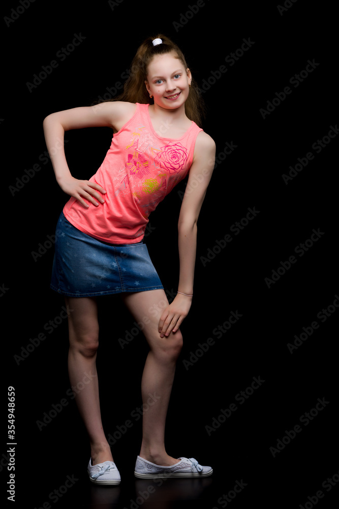 Fashionable girl teenager studio photo on a black background. Fashionable girl teenager studio photo on a black background.
