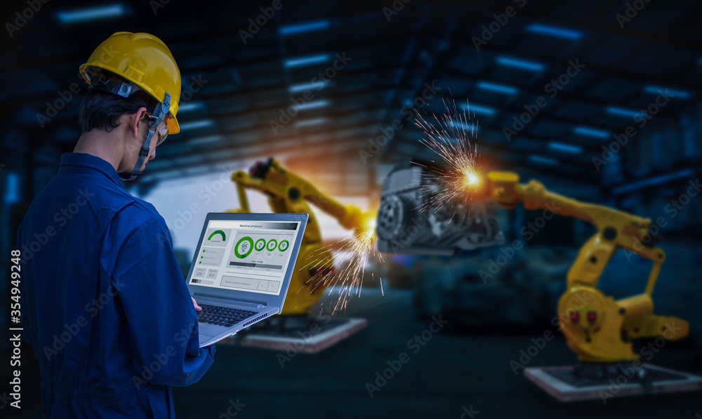 Industry 4.0 Robot concept .Engineers use laptop computers for machine ...