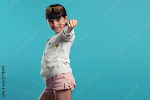 portrait of a cute smiling girl on a blue background