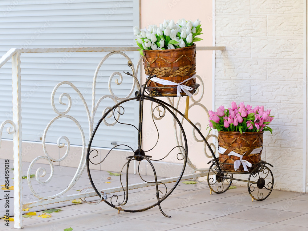 Beautiful view of creative entrance to cafe is decorated decorative bicycle with flowers. Selective focus and space in the zone blurring compositions for production of advertising and text.