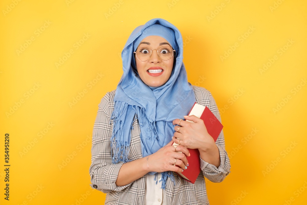 Young beautiful muslim woman wearing hijab having broad white smile being excited to meet Friends and go out to have a good day. Young beautiful muslim woman wearing hijab having broad white smile being excited to meet Friends and go out to have a good day.