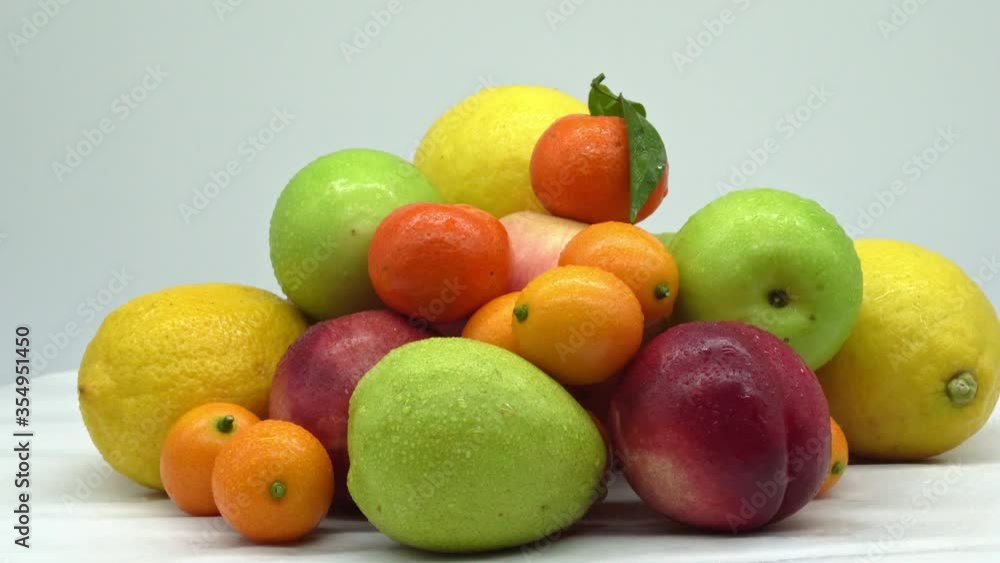 Closeup of a bunch of organic healthy fruits, fresh mature juicy fruits are a storehouse of useful vitamins. Oranges, apples and lemons Closeup of a bunch of organic healthy fruits, fresh mature juicy fruits are a storehouse of useful vitamins. Oranges, apples and lemons