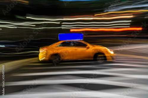 New York City yellow taxi cab in motion across broadway in Manhattan