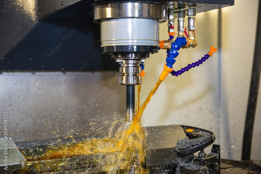 The CNC milling machine cutting the tire mold parts with liquid oil coolant method. The mold and