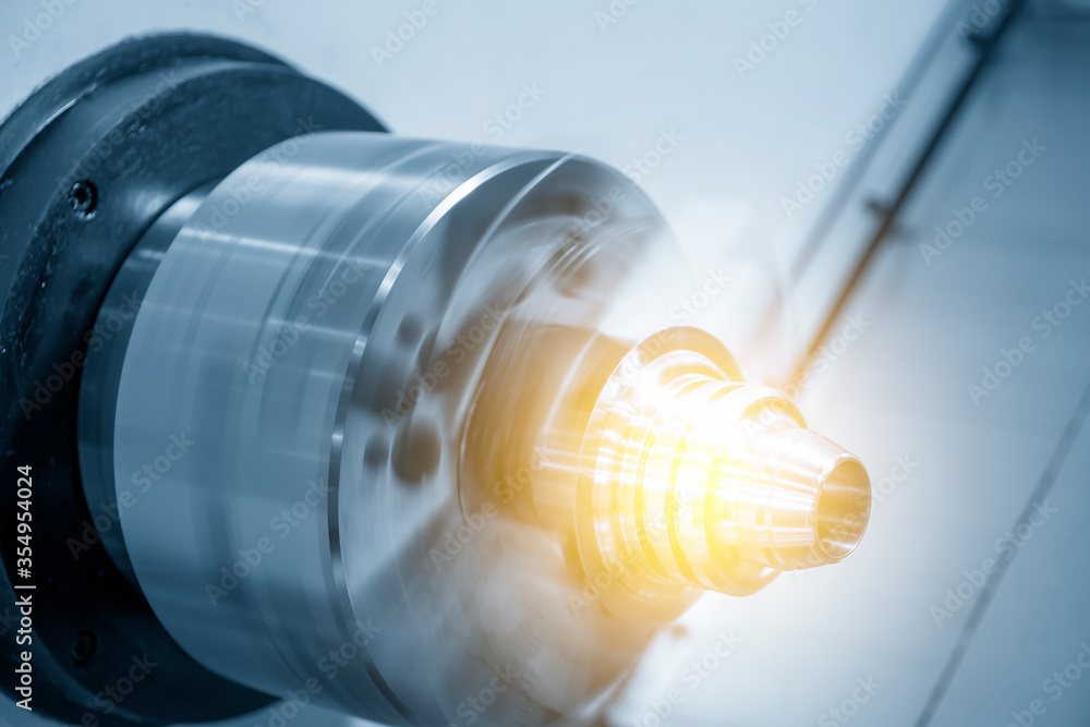 CNC lathe chucking the metal cone shape parts with lighting effect. The hi-technology metal working processing by CNC turning machine . CNC lathe chucking the metal cone shape parts with lighting effect. The hi-technology metal working processing by CNC turning machine .