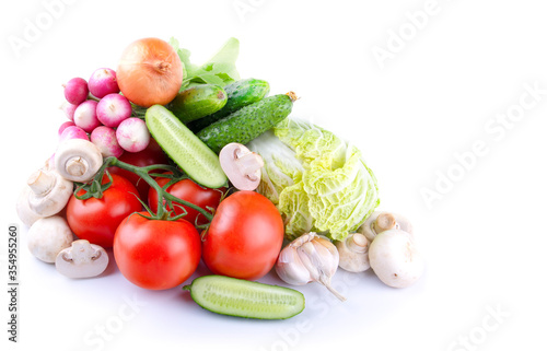 Fototapeta Naklejka Na Ścianę i Meble -  vegetables tomatoes, lettuce, radishes, mushrooms champignon , cucumbers, garlic on a white isolated background