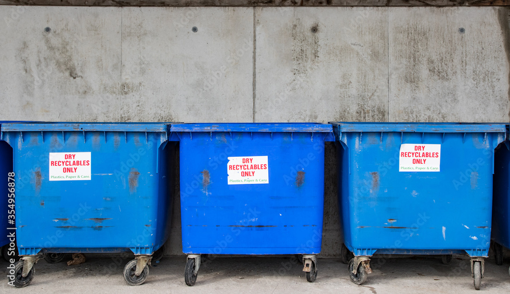 Big blue recycling containers for recycling plastics, paper and cans Big blue recycling containers for recycling plastics, paper and cans