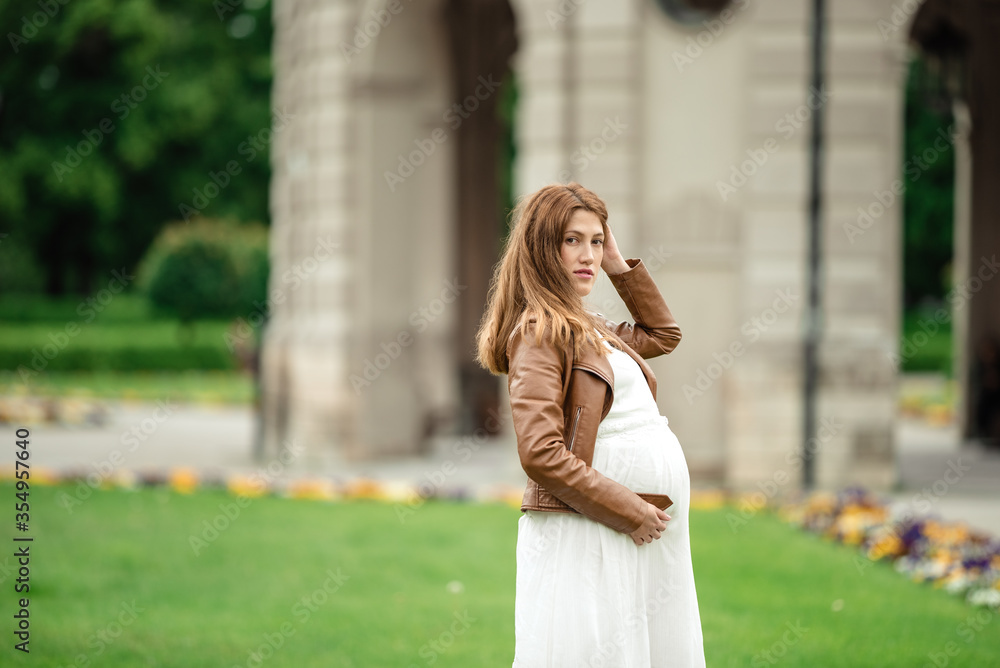 pregnant brunette woman at an old building gazebo. pregnant brunette woman at an old building gazebo.