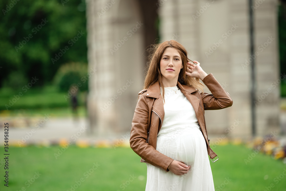 pregnant brunette woman at an old building gazebo. pregnant brunette woman at an old building gazebo.