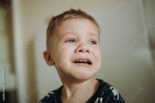 portrait of crying cute little baby boy. Image with selective focus 