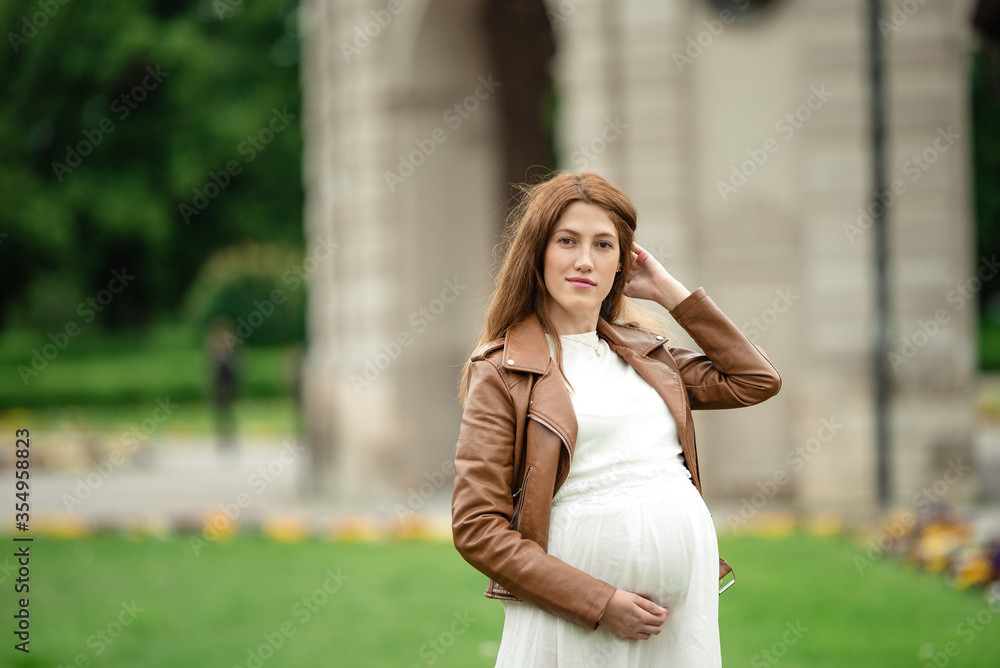 pregnant brunette woman at an old building gazebo. pregnant brunette woman at an old building gazebo.