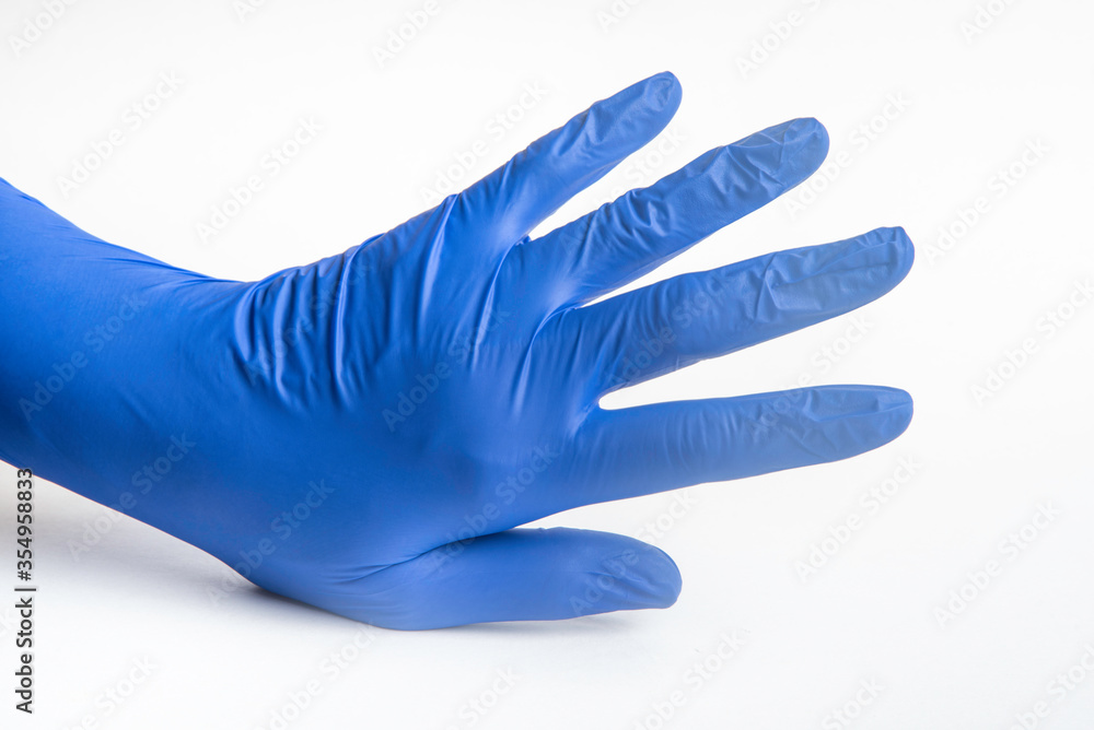 Hands wearing blue latex disposable gloves set on plain white background. Hands wearing blue latex disposable gloves set on plain white background.