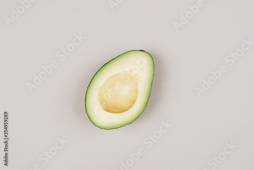 Fresh green avocado on a grey background. Top view.