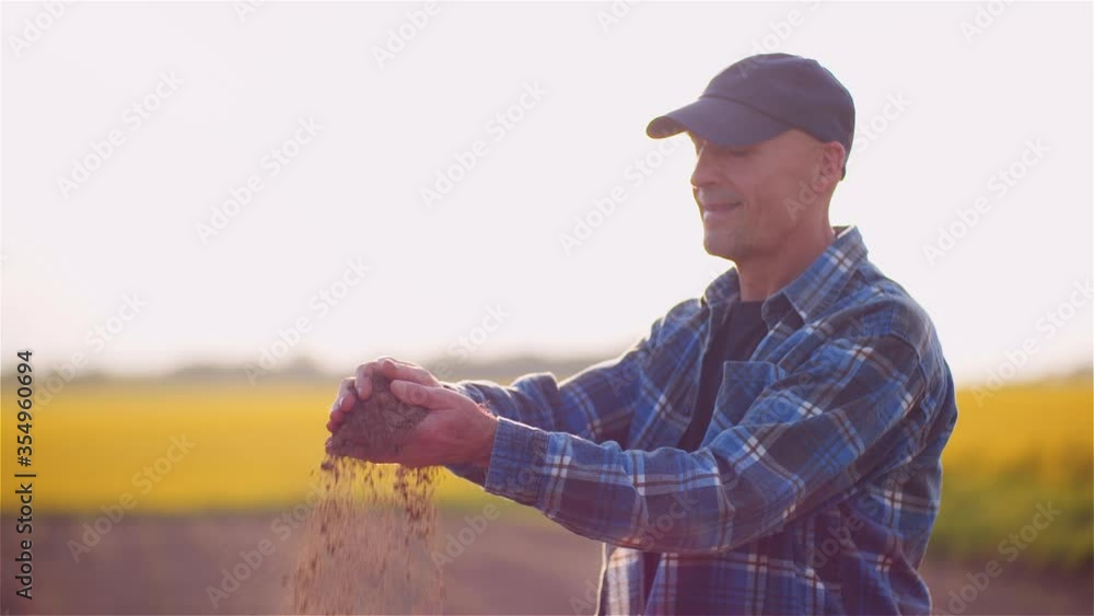 Farmer Examining Soild Dirt in Hands at Dusk Farmer Examining Soild Dirt in Hands at Dusk