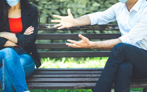 Young male and female arguing outdoors, couple misunderstanding