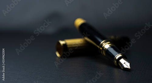 Photos Beautiful fountain pen. under exposed photo on a black background