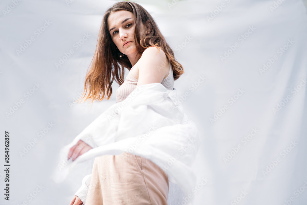 Portrait of a young woman with natural makeup, looking into the camera. Dressed in a white shirt. Portrait of a young woman with natural makeup, looking into the camera. Dressed in a white shirt.