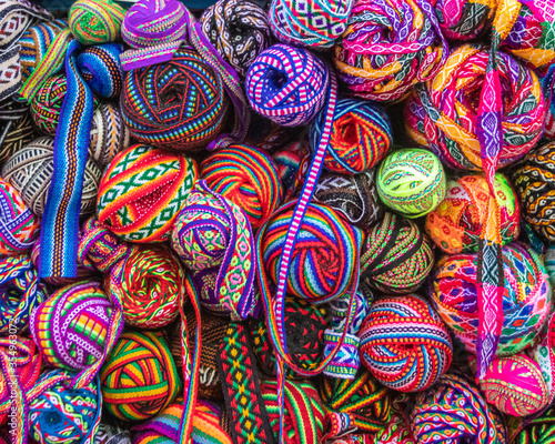 A myriad of colorful  woven textiles for sale in a market