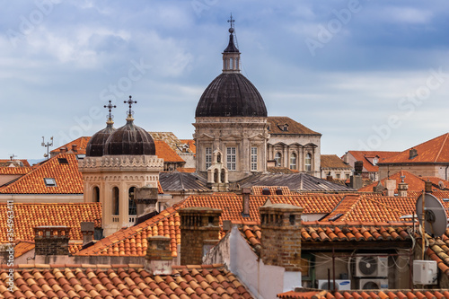 The domed rooftops of Old Town, Dubrovnik Croatia rise above the terra cotta roof lines