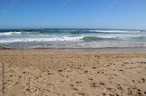 The beach of Wilderness and wild Indian Ocean on Garden Route  South Africa  Africa. The air is dusty because of the strong wind and high surf.