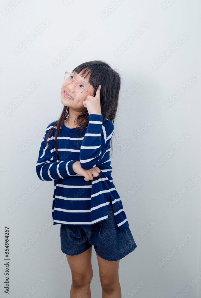 Portrait of little kid boy isolated over white background showing tongue. Funny little power super hero kid showing muscles. Image of a little toddler surprise, a little girl standing alone over Portrait of little kid boy isolated over white background showing tongue. Funny little power super hero kid showing muscles. Image of a little toddler surprise, a little girl standing alone over