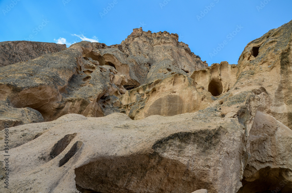 The caves of the ancient rock monastery of Selime, carved into the mountains in the valley of Ihlara, Cappadocia, Turkey