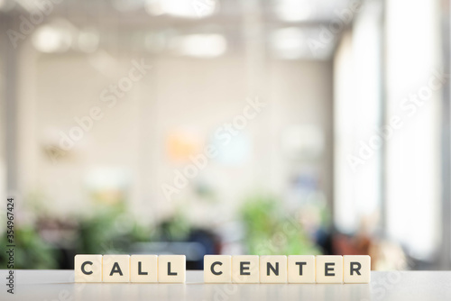 white blocks with call center lettering on white desk